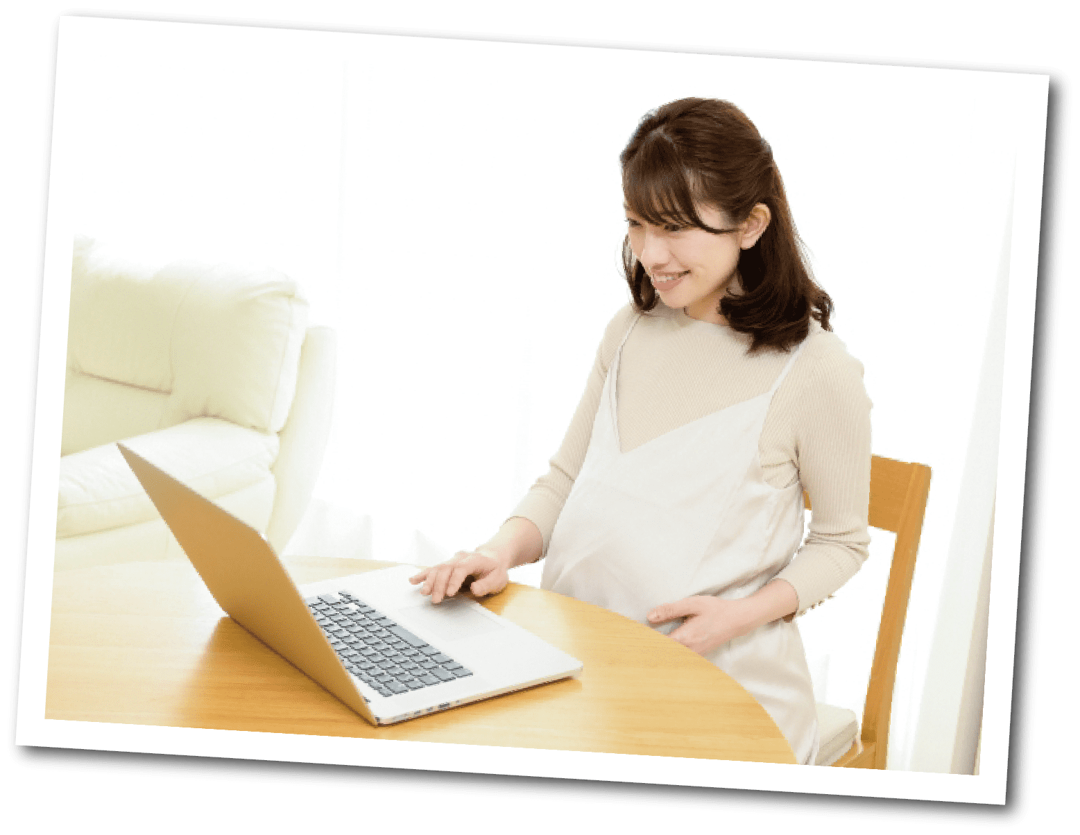 妊娠中の女性がパソコンを見ている写真